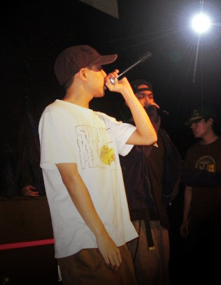 Photo of young Jon Protege performing with his then group, Talksic Ways. Posted by Lyrically Deranged Poets (LDP) in 2009.